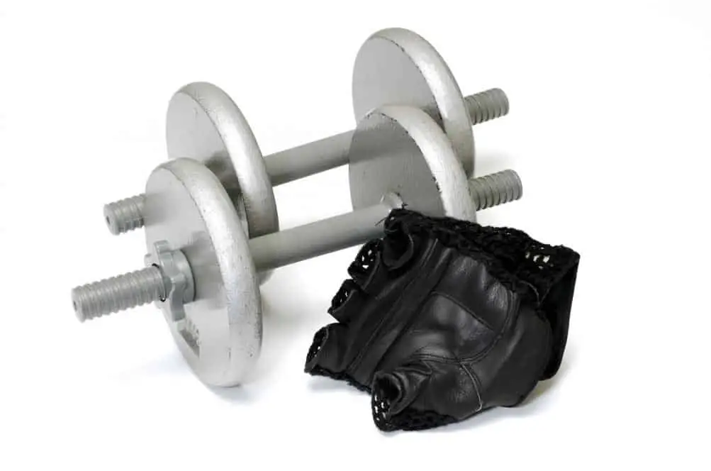 Isolated workout gloves and dumbbells